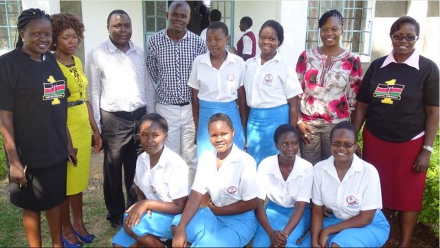ncic officers with a section of amani club officials of st. alloys girls in kisumu county